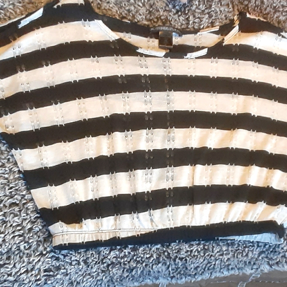 A stripped black and white shirt over the should